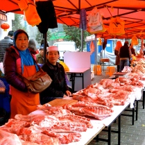 A couple selling raw meat at the Muslim Market